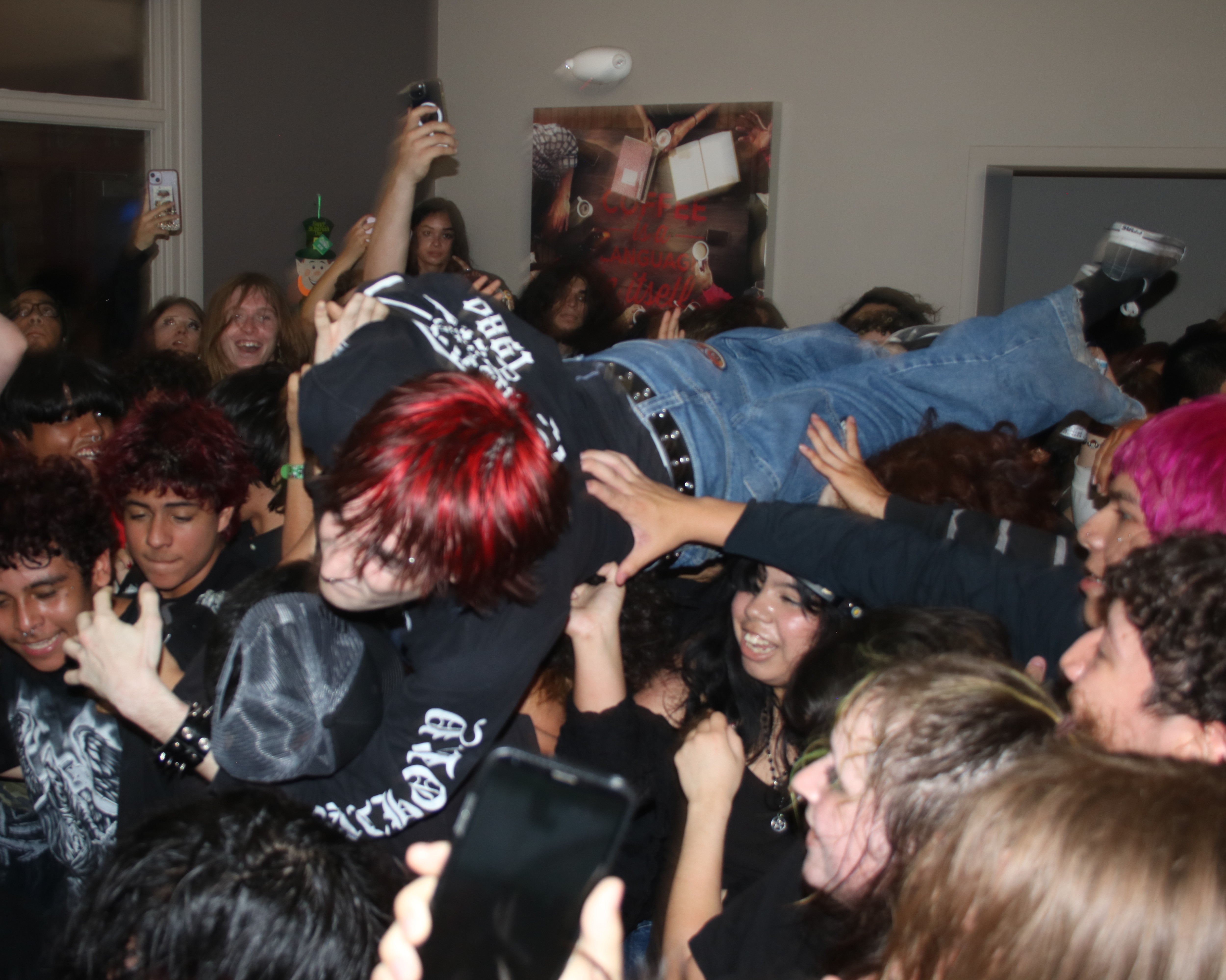 Photo of guy being held up by a sea of people