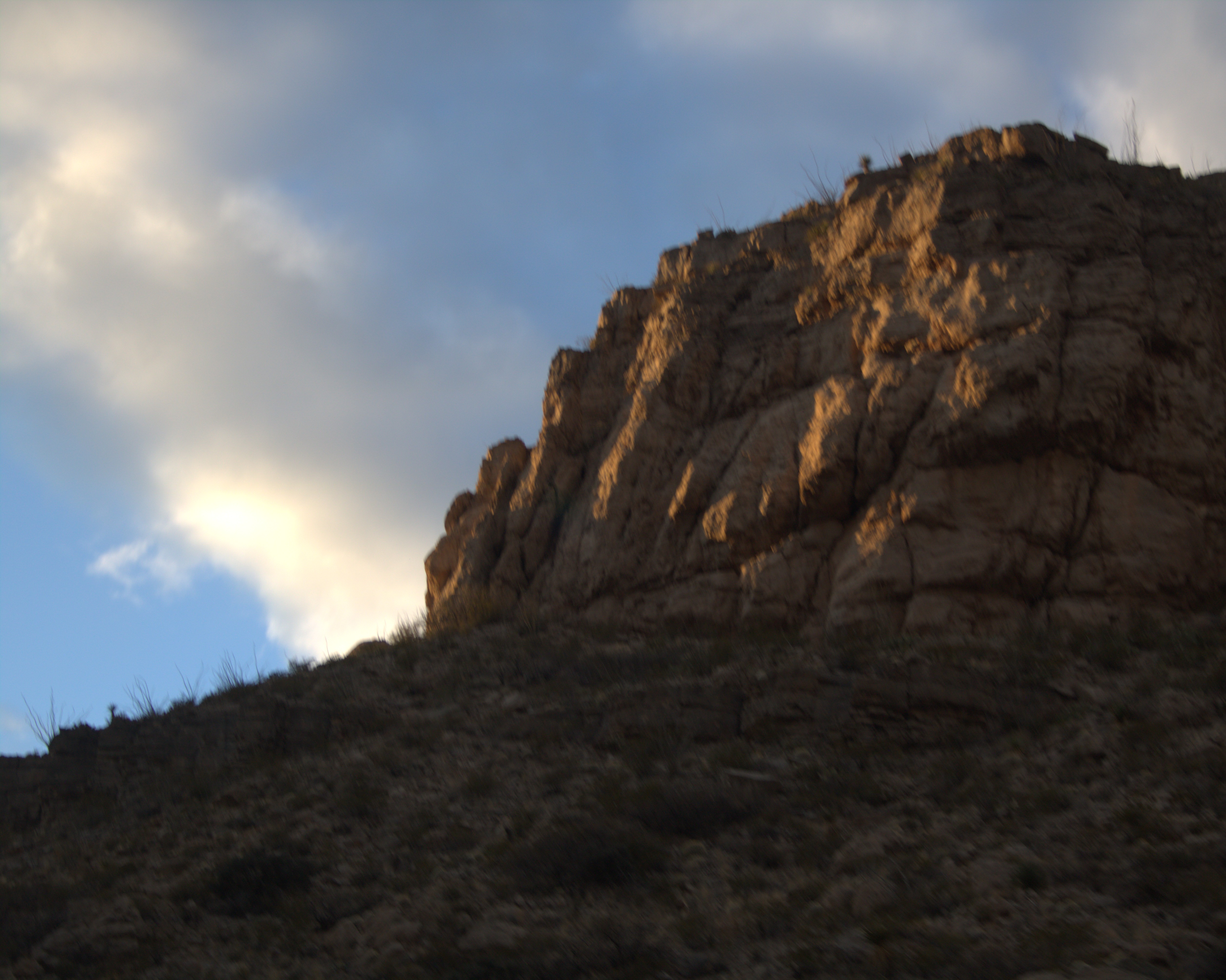 photo of tip of mountain against blue sky background