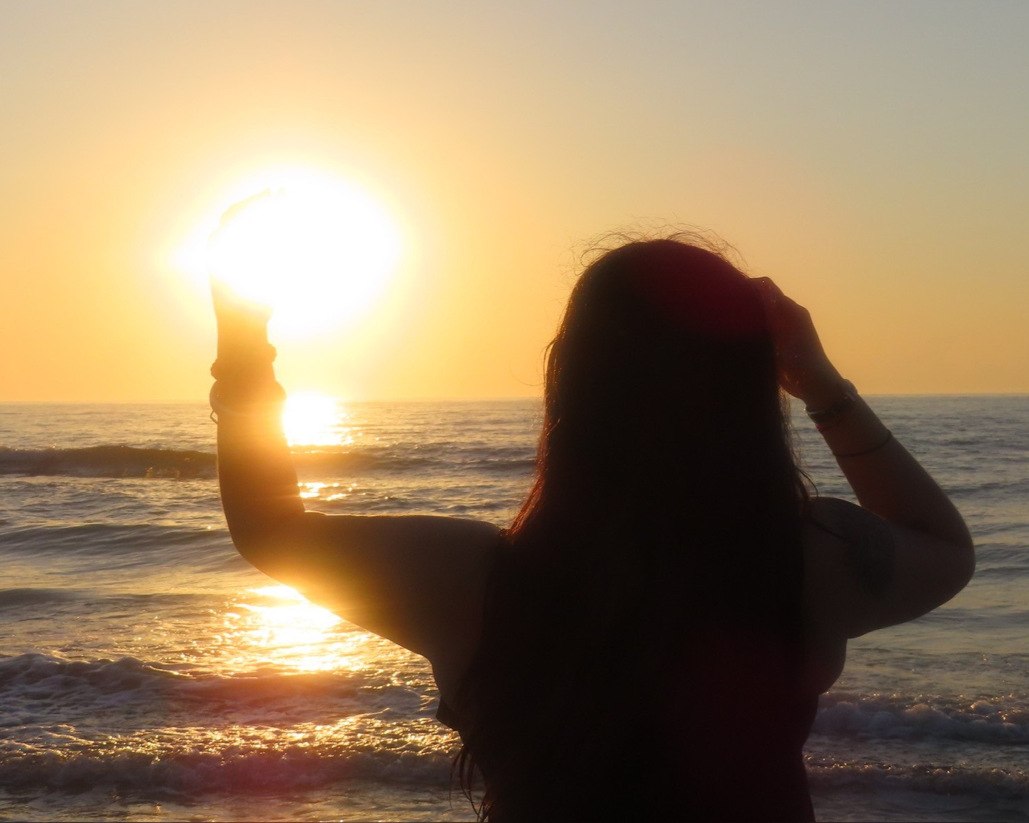 photo of girl facing ocean sunset